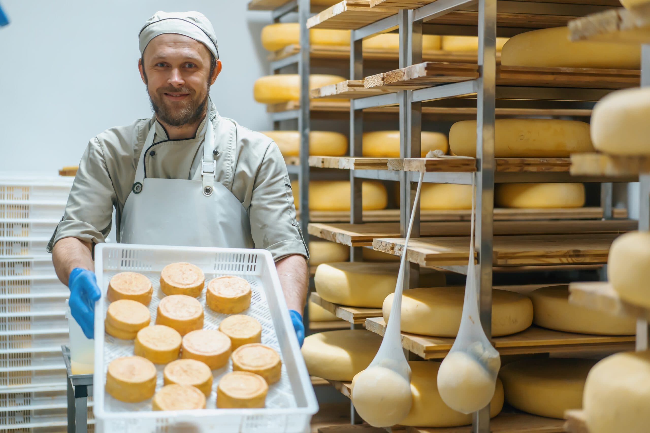 Smiling,Cheese,Maker,Holding,Crate,Fresh,Cheese,In,Dairy,Farm