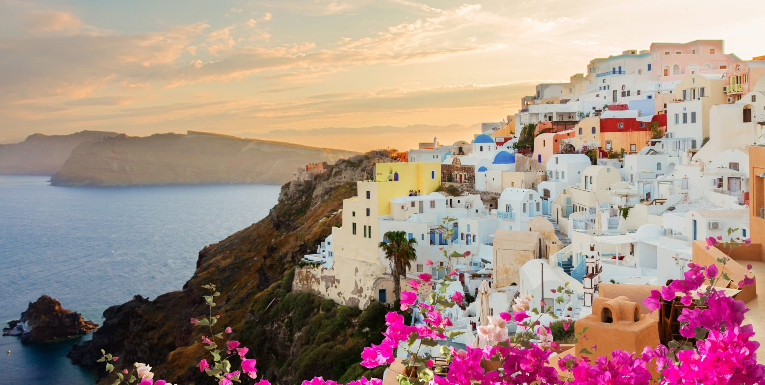 Townscape,Of,Oia,With,Flowers,,Volcano,Caldera,And,Aegan,Sea,
