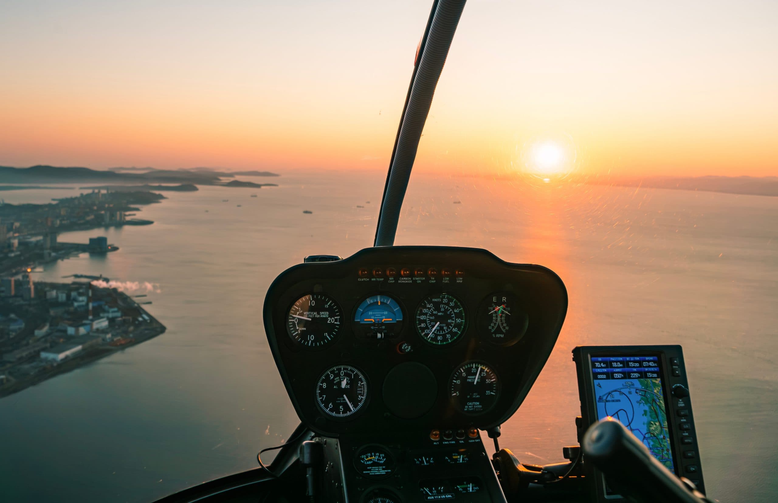 Helicopter,Cockpit,View,During,Sunset,Over,Coastal,City,With,Calm