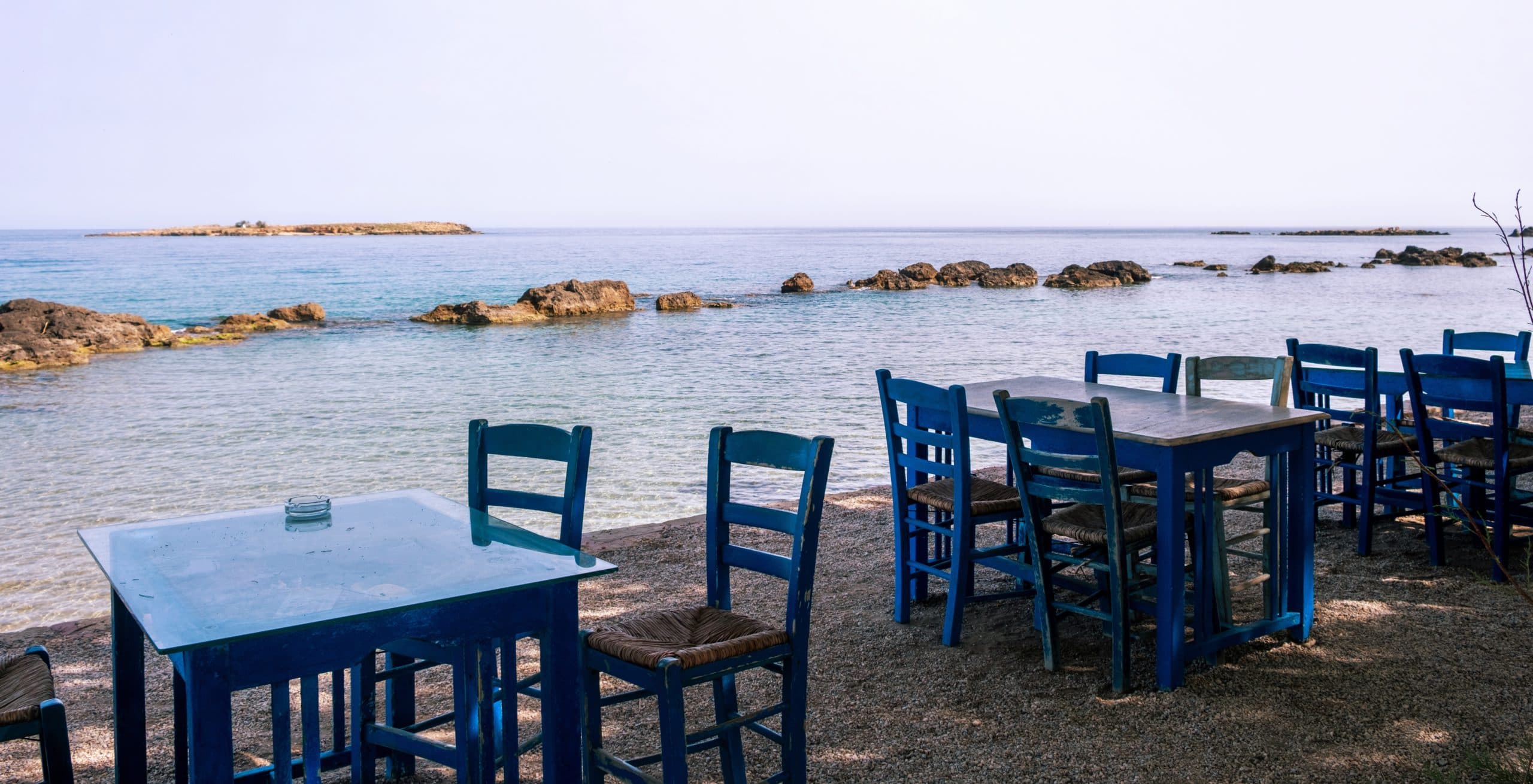 Blue,Wooden,Chairs,And,Tables,At,A,Seaside,Taverna,Face