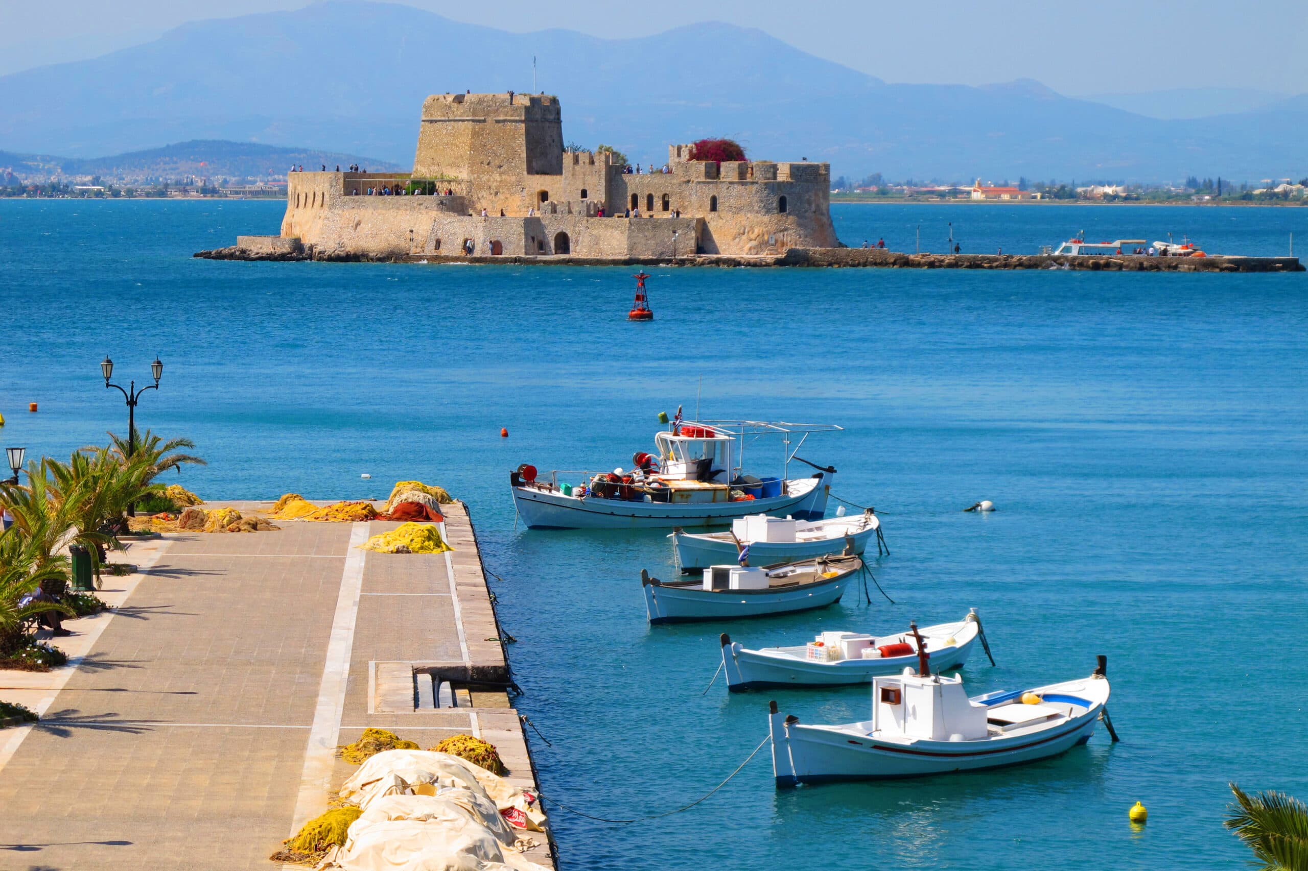 Photo,Of,Traditional,Fishing,Boats,And,Bourtzi,Fortress,In,Picturesque