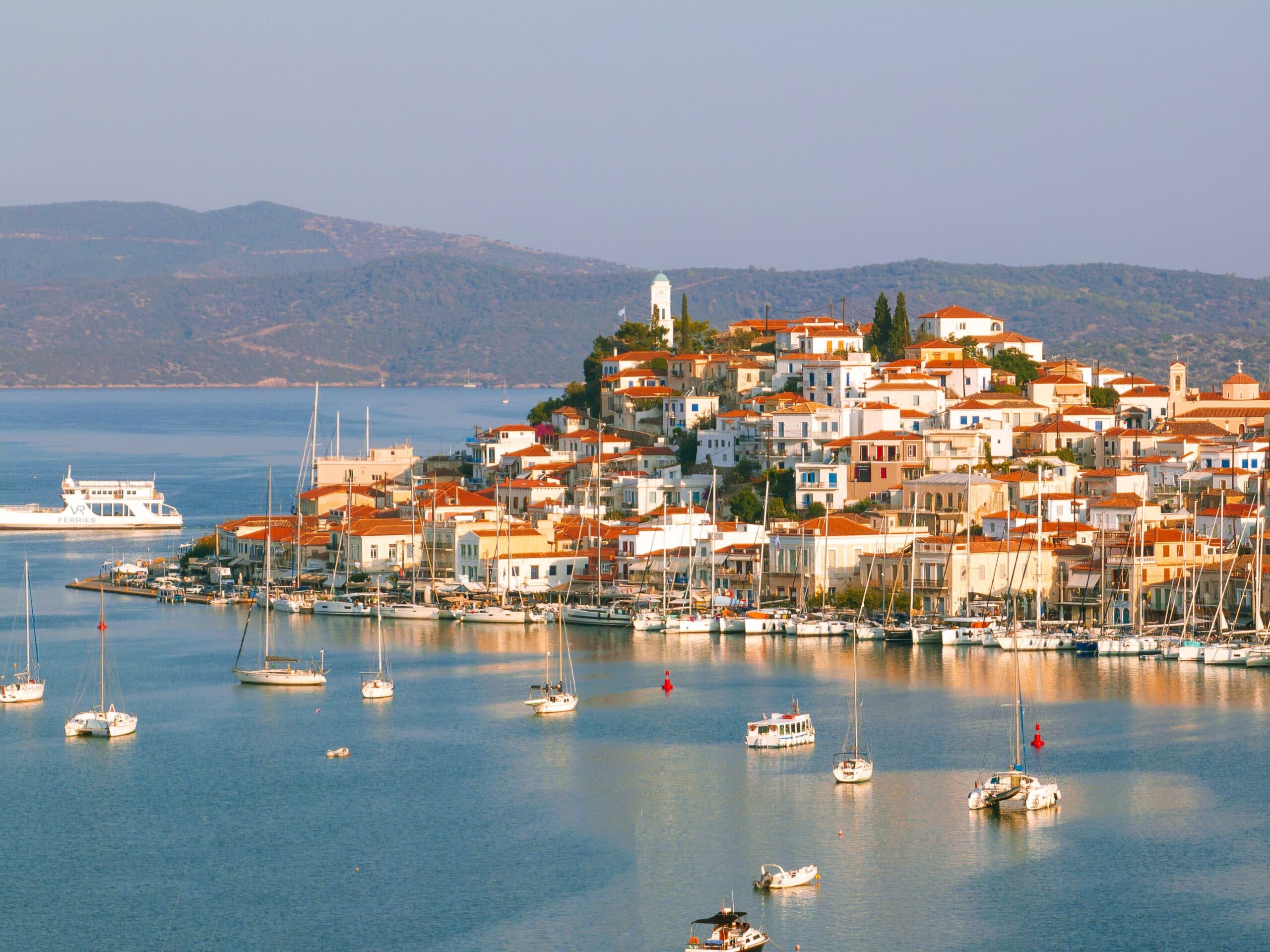 Aerial,View,Poros,Island,,Greece,With,Red-roofed,Houses,,Lush,Hills