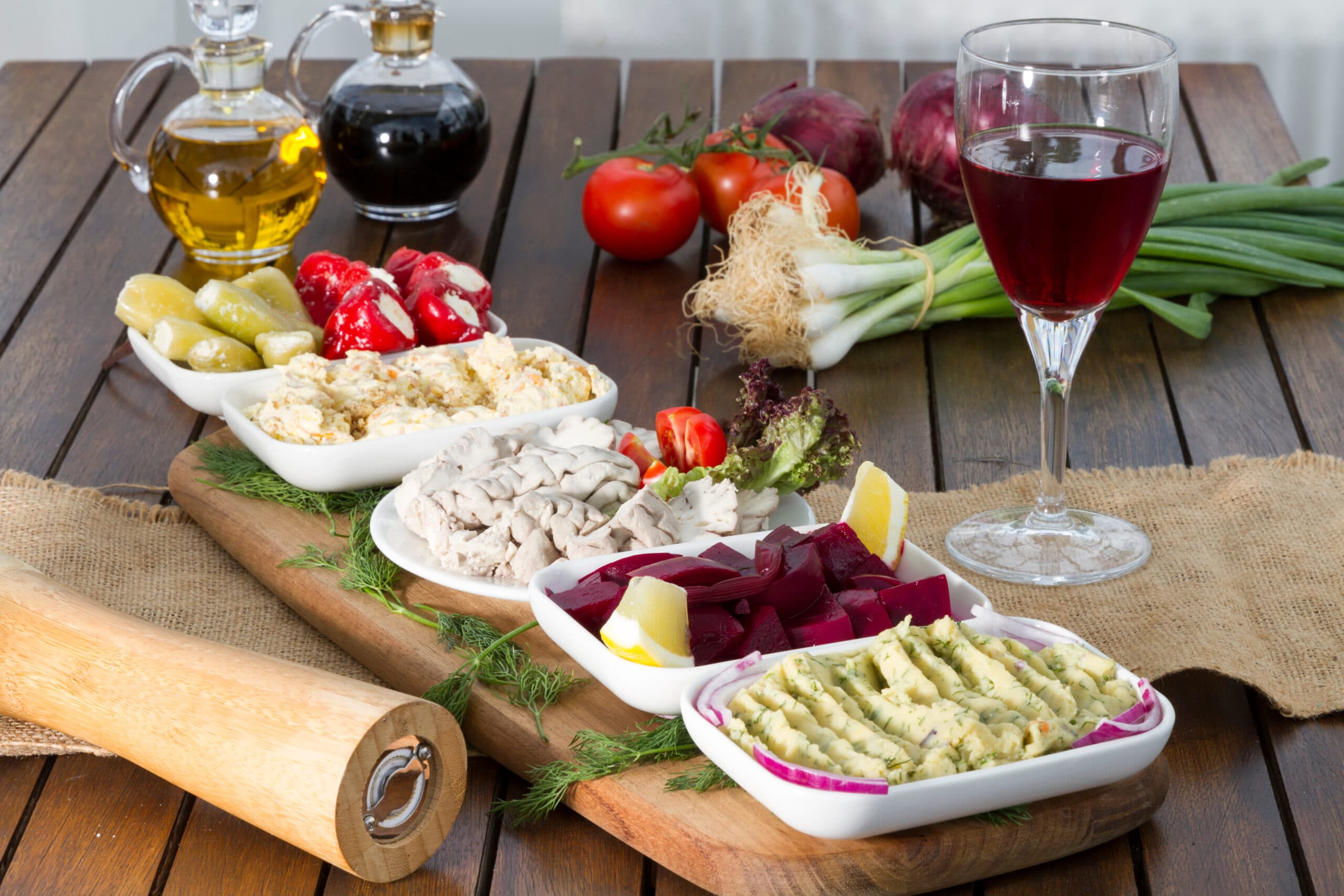 Wooden,Board,With,Plates,Of,Green,And,Red,Peppers,Stuffed