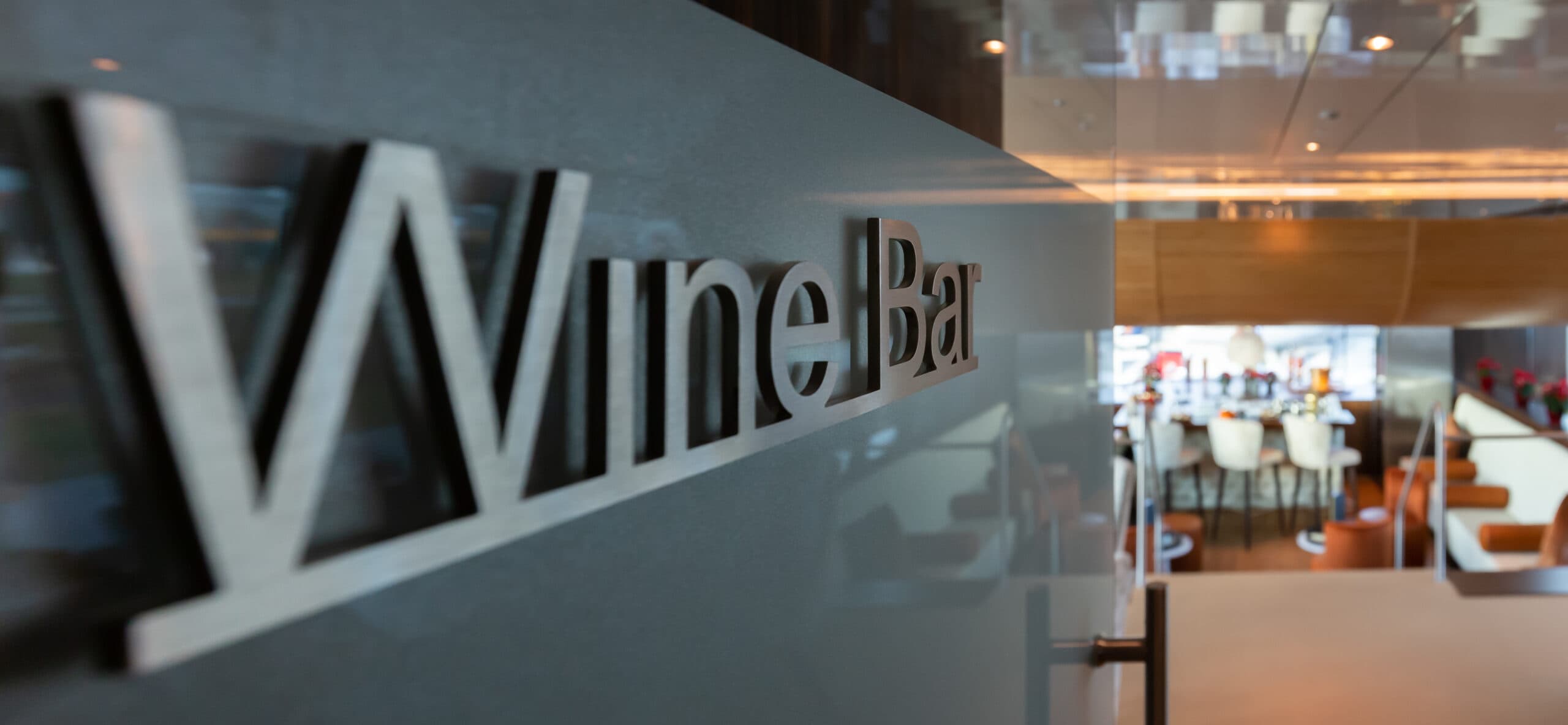 A,Closeup,Of,A,Gray,Metallic,"wine,Bar",Sign,On