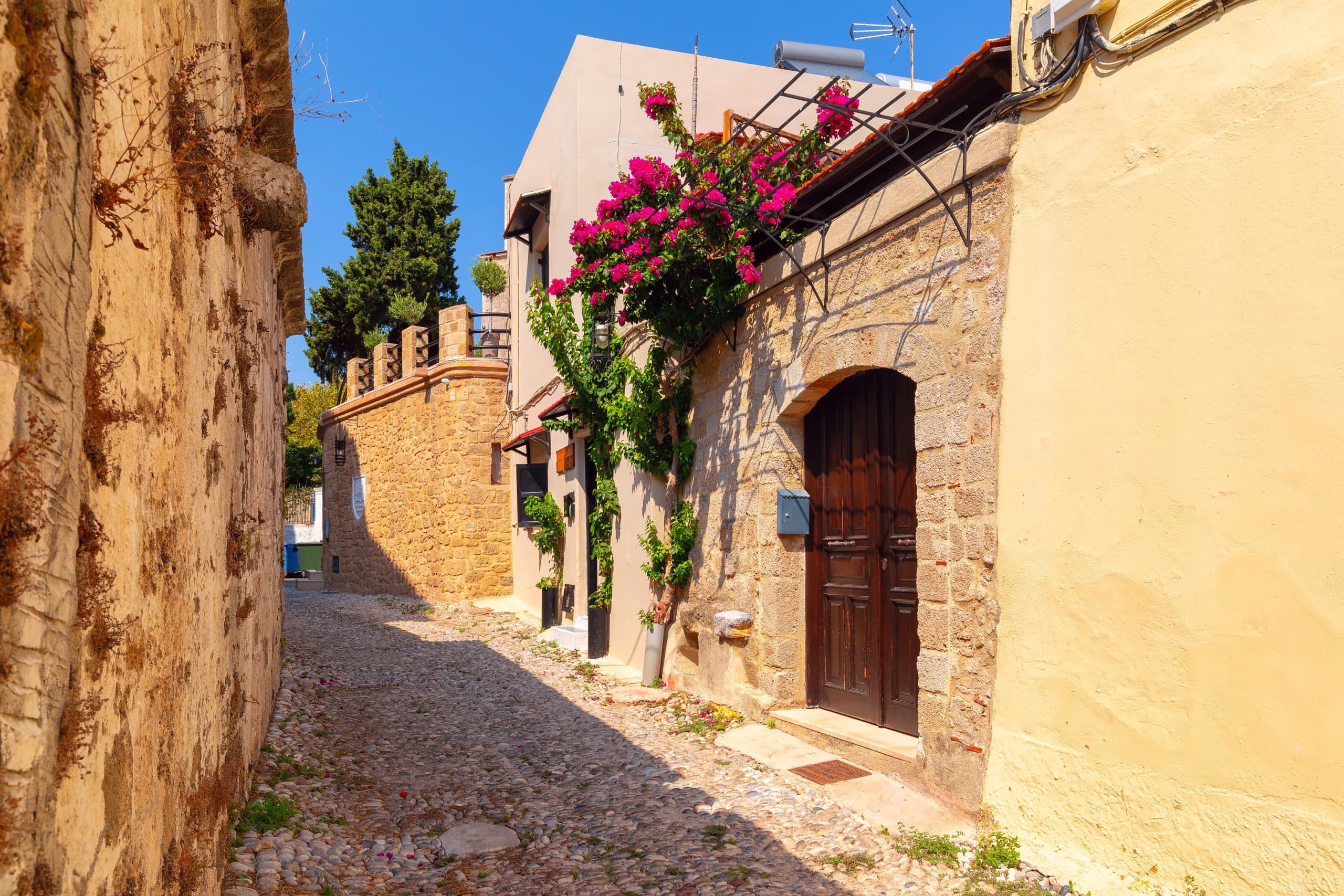 Narrow,Medieval,Street,With,Arch,And,Flowers,,Rhodes,Old,Town,