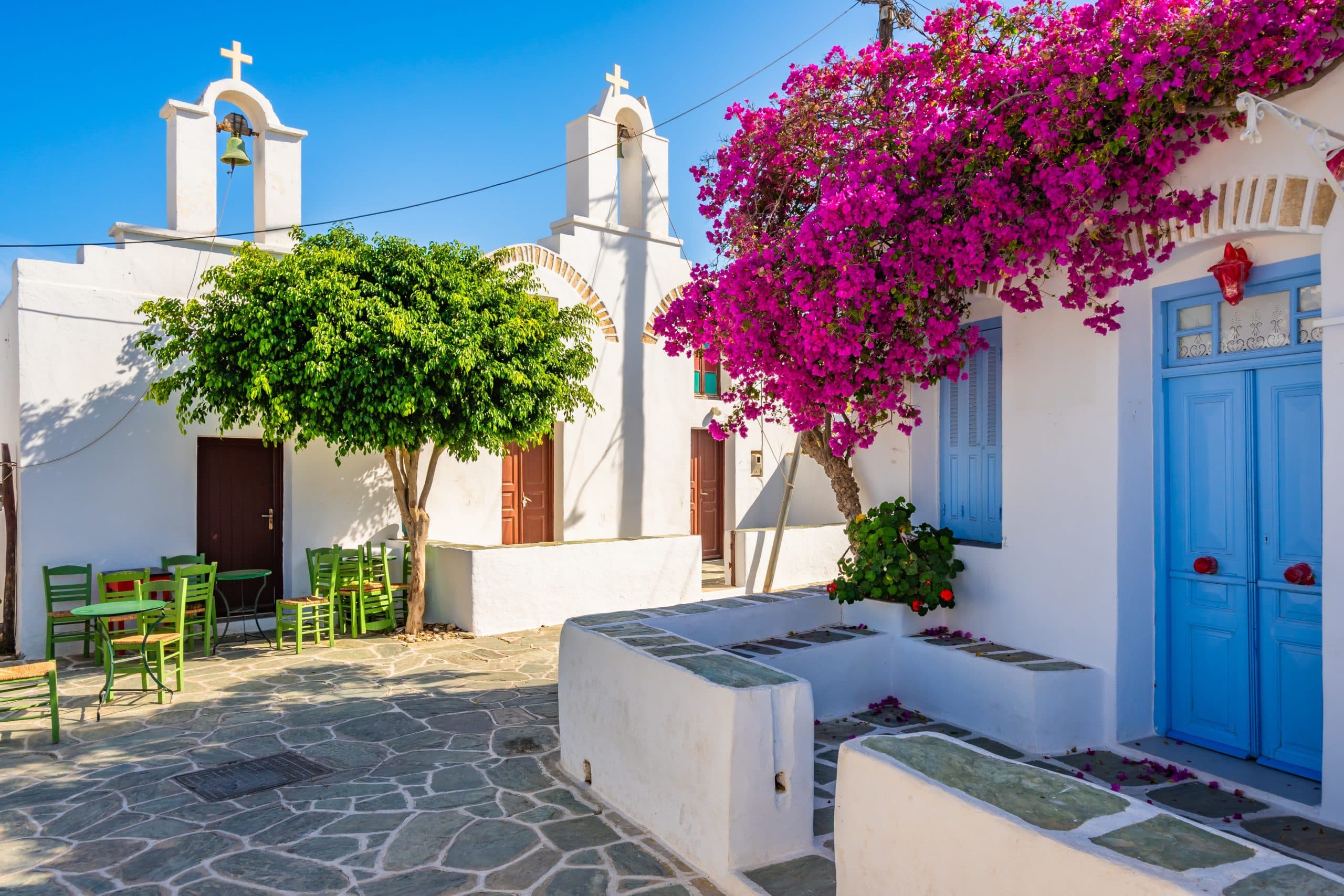 White,House,With,Flowers,And,Church,Buildings,On,Street,In
